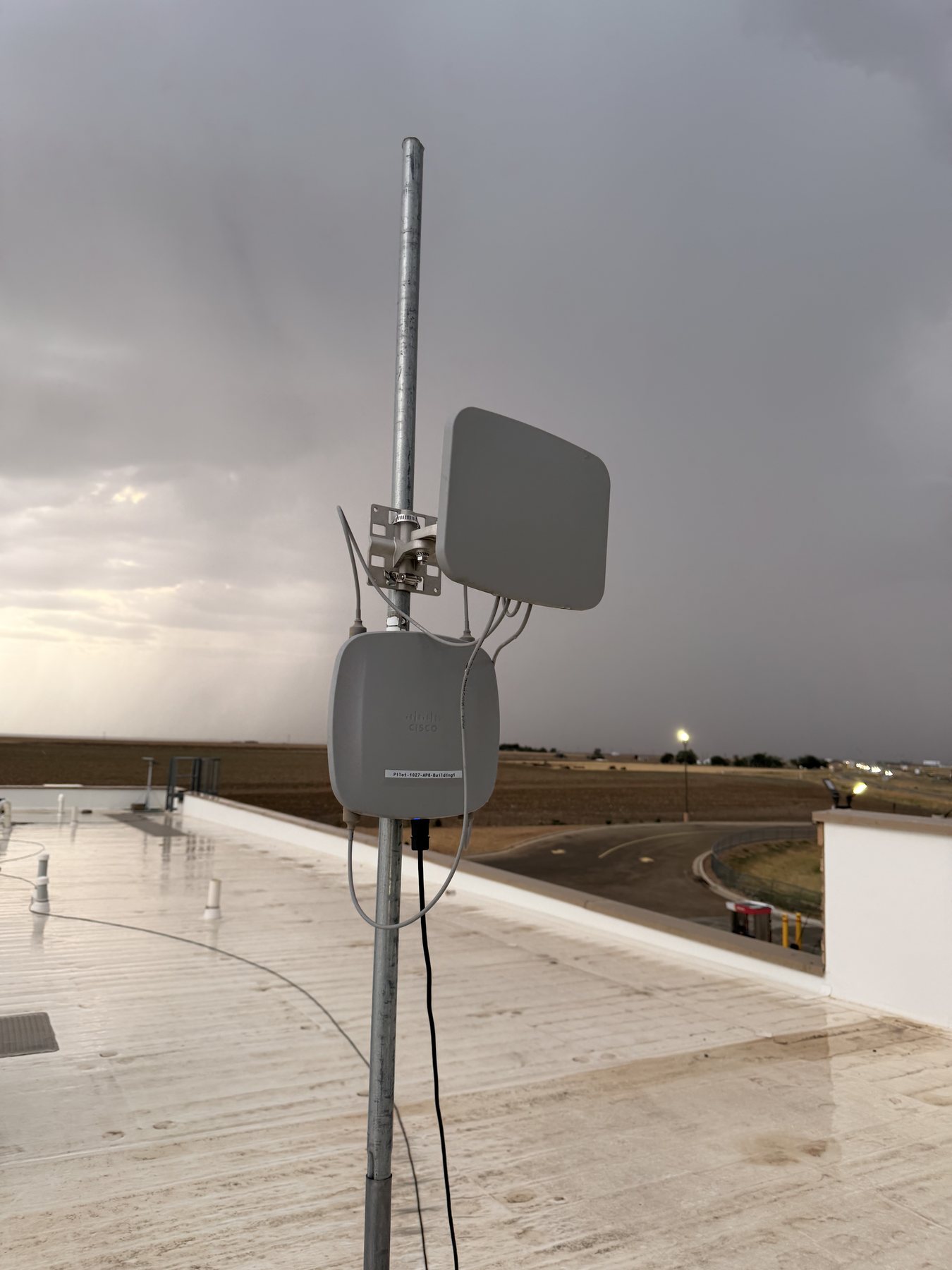 Outdoor wireless access point and panel antenna installed on a rooftop