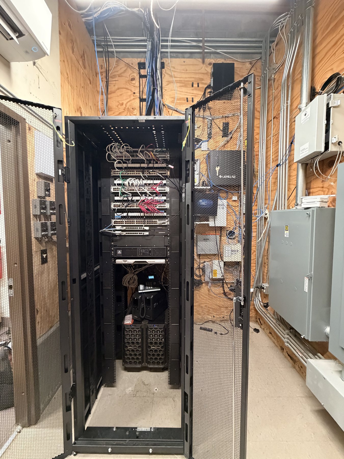 Same network equipment organized inside a serviceable cabinet
