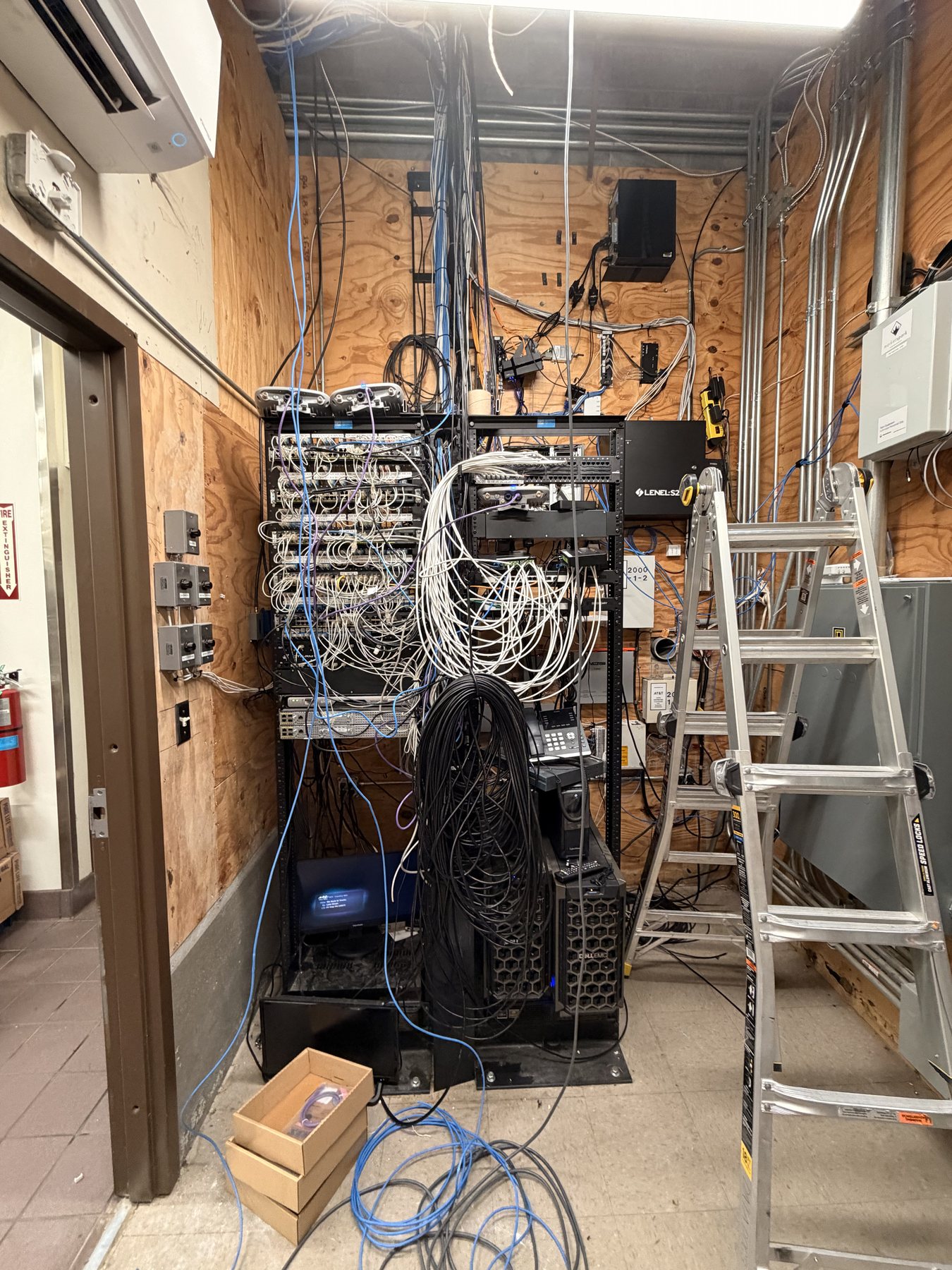 Network rack before rebuild with loose and tangled cabling